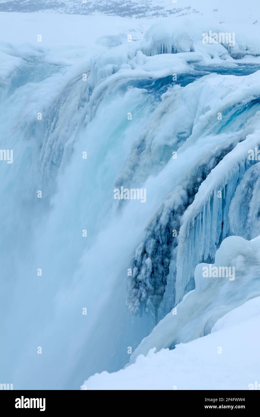 Teilweise gefrorener Goðafoss Wasserfall während der Winterbedingungen zeigt fließendes Wasser Und Eis auf dem Fluss Skjálfandafljót in Island Stockfoto