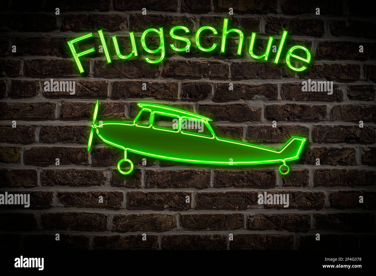 Leuchttreklame für eine Flugschule ein Flugzeug befindet sich in der Neon-Schrift Leuchtwerbung für eine Flugschule ein Flugzeug Ist Stockfoto