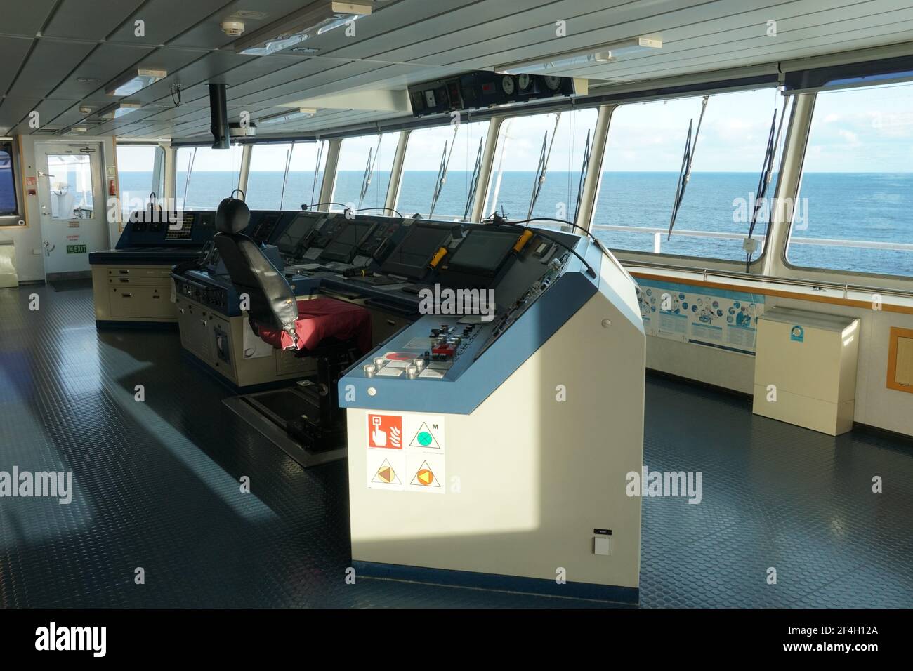 Die moderne Schiffsbrücke Steuerkonsole mit Navigationsausrüstung des Containerschiffes mit Blick auf das Meer. Stockfoto