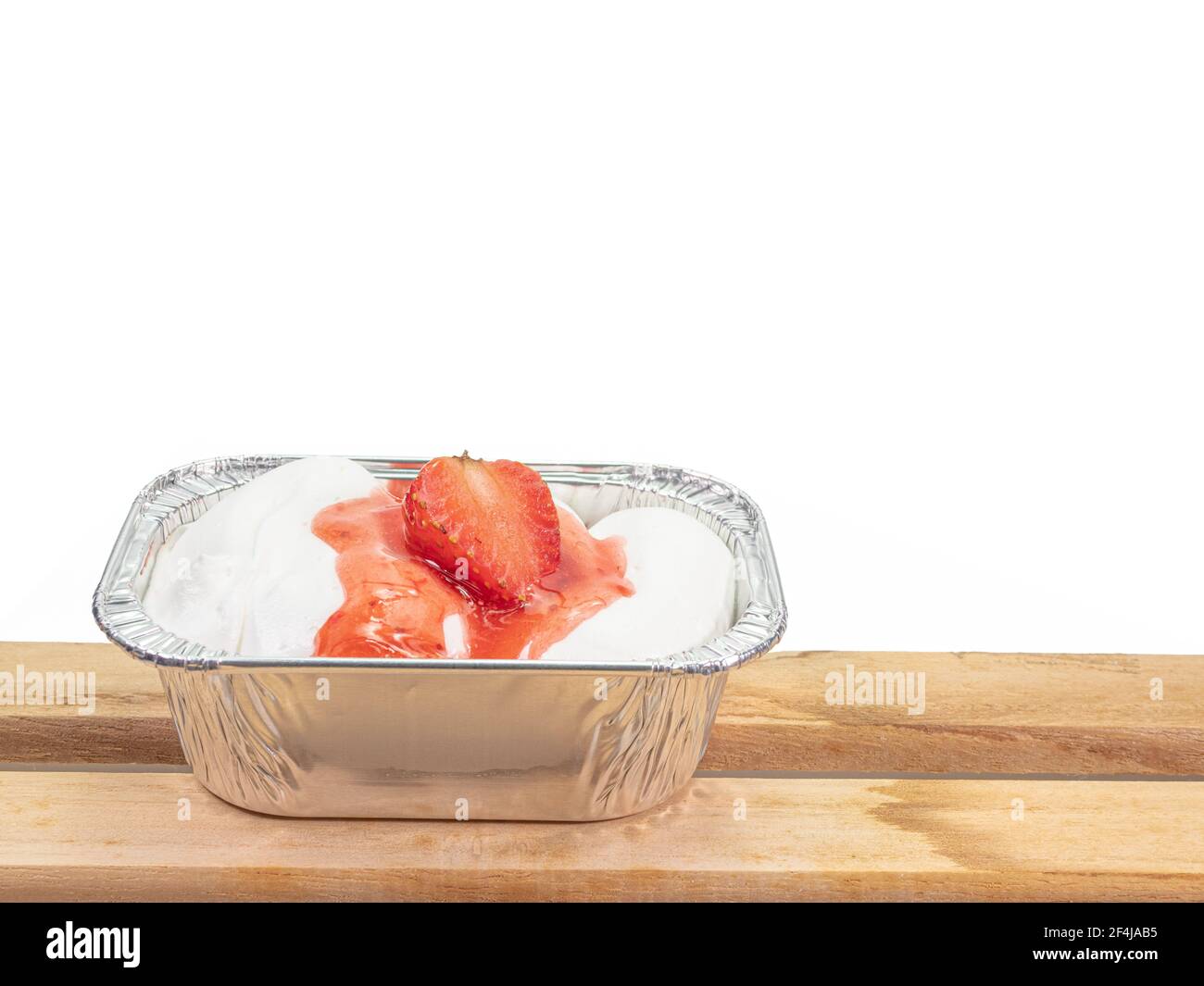 Erdbeerkuchen, eine Nahaufnahme der hausgemachten Sahne Kuchen mit Erdbeere Belag in Aluminiumfolie Tasse isoliert auf weißem Hintergrund. Stockfoto