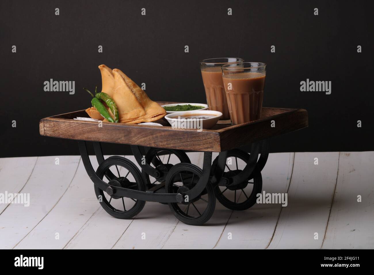 Indische Snack hausgemachte würzige und köstliche Samosa serviert mit grünen, Tamarinde Chutney Schneiden Masala Tee, Chai, Stockfoto