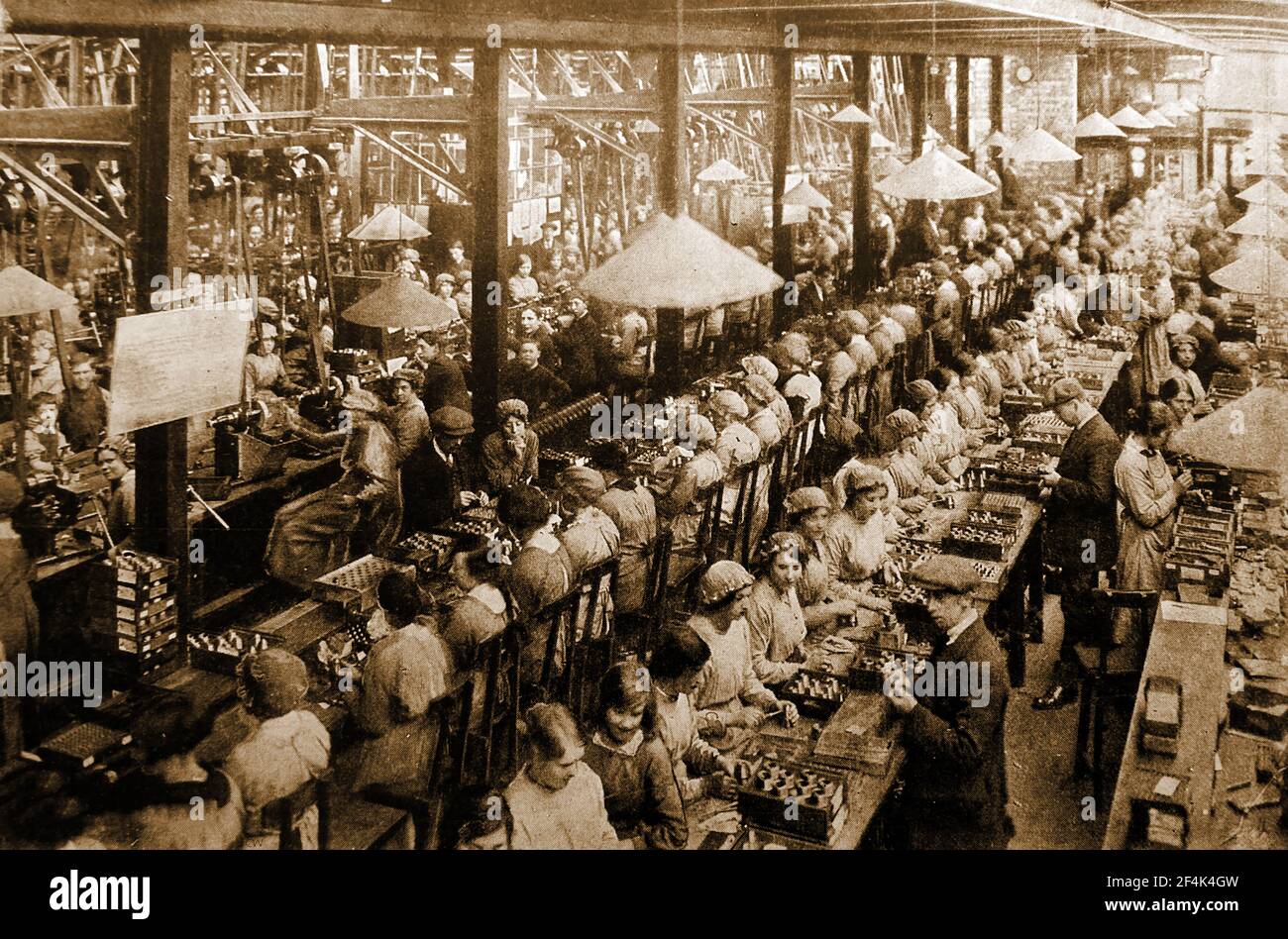Ein altes Foto, das während des Ersten Weltkrieges aufgenommen wurde und hauptsächlich Frauen und junge Arbeiter zeigt, die Schalensicherungen in einer britischen Munitionsfabrik zusammenbauen. Stockfoto