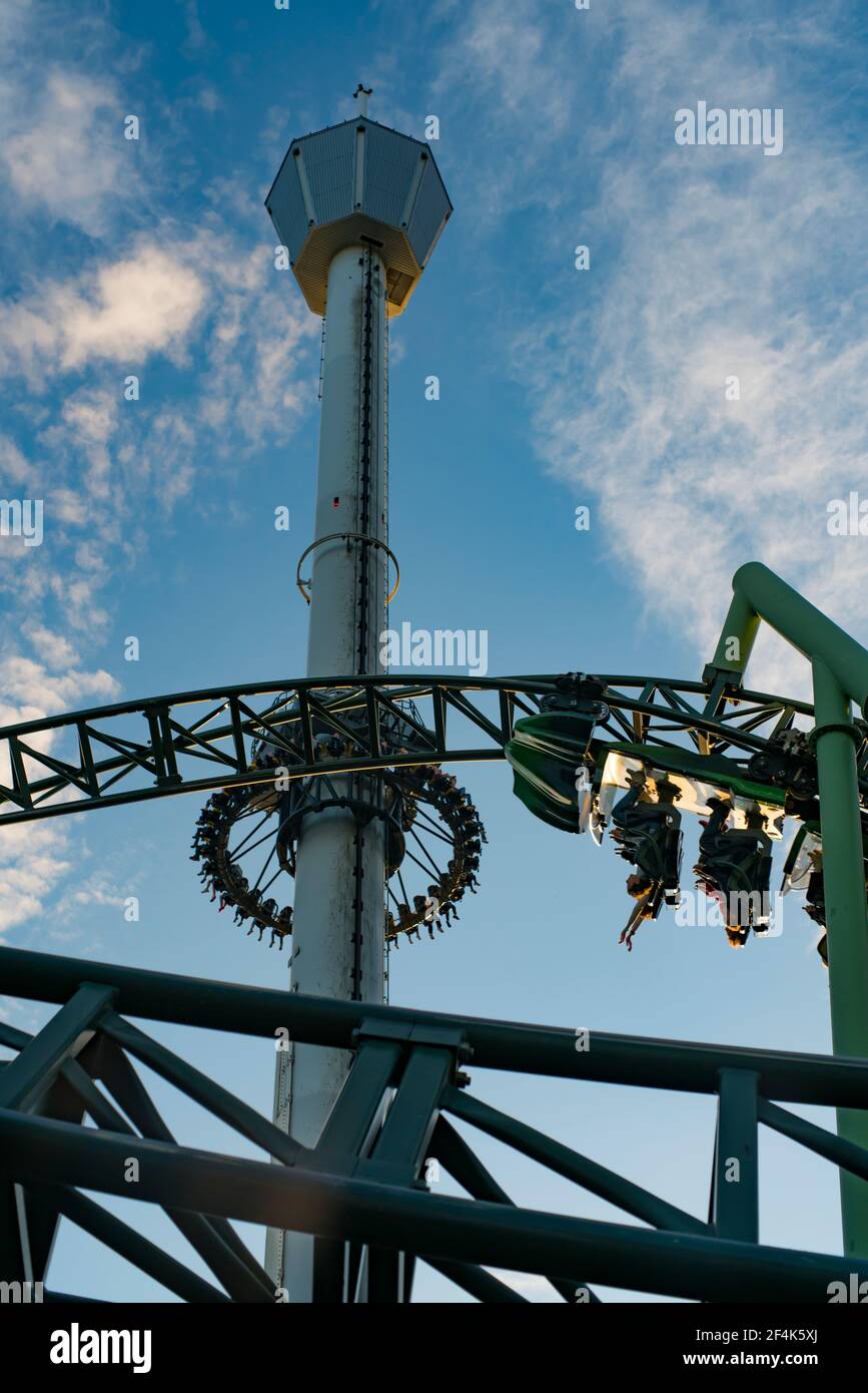 Menschen, die während der Roller Coaster Ride Helix schreiend und die Hände hochhalten Stockfoto