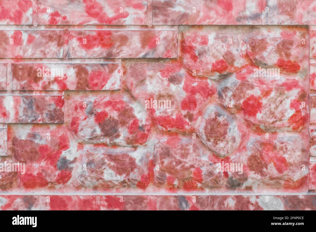 Dekorative Ziegel und Steinzaun mit abstrakten rot gepunkteten Muster modernen Innenwand Textur Hintergrund. Stockfoto