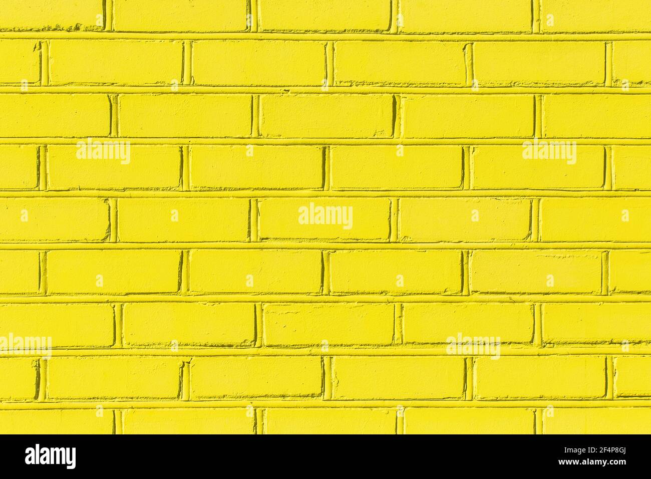Gelbe Farbe hell Licht Backstein alte Stadtmauer Textur Hintergrund. Stockfoto