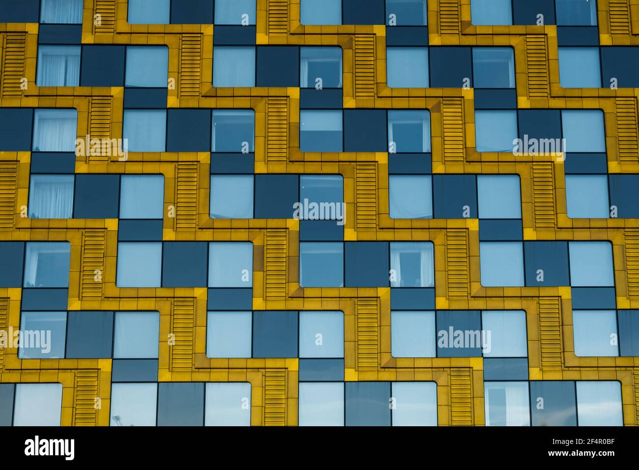 Fragment der modernen Gebäudefassade aus grauen und gelben Farben. Stockfoto