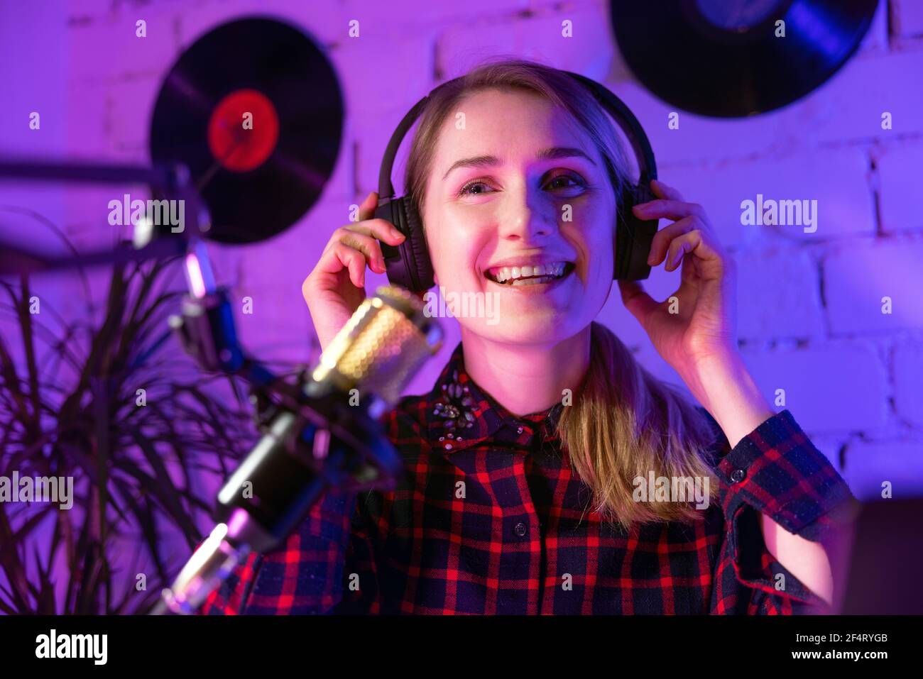 Glückliche Frau Radio-Host mit Kopfhörern im Studio zu senden Stockfoto