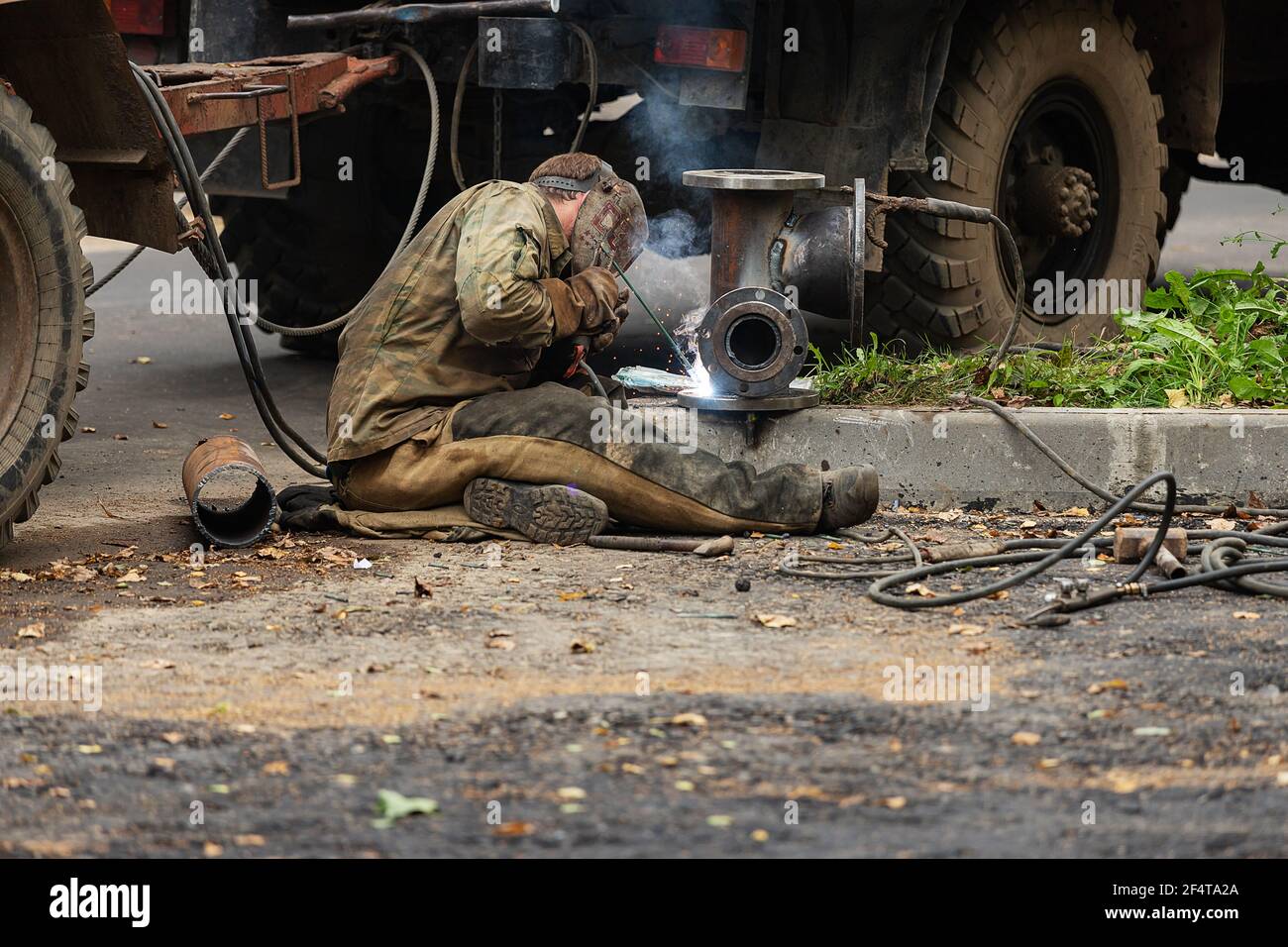 Schlecht durchgeführte Straßenreparaturen. Austausch des alten Bordsteines durch einen neuen Stockfoto