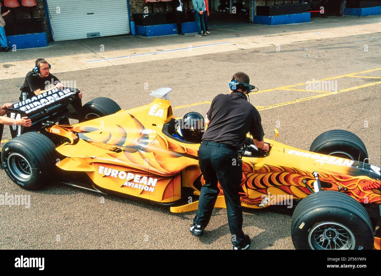 2001 Donington Park Rennbahn ,Castle Donington ,Leicestershire ,East Midlands, England, GB, UK, Europa - Paul Stoddart fährt Neale Clark in einem europäischen Formula Racing Zweisitzer Minardi F1 Rennwagen aus den Boxen auf der Donington Park Rennbahn. Diese bemerkenswerte zweisitzige Racing Car Passenger Ride gibt einen Nervenkitzel in halsbrecherischer Geschwindigkeit für eine Eimer Liste Erfahrung des Lebens. Paul Stoddart, ab dem Grand Prix von Spanien 2017, bietet Fans die Möglichkeit, in einem seiner Minardi FX2 Autos fahren Stockfoto