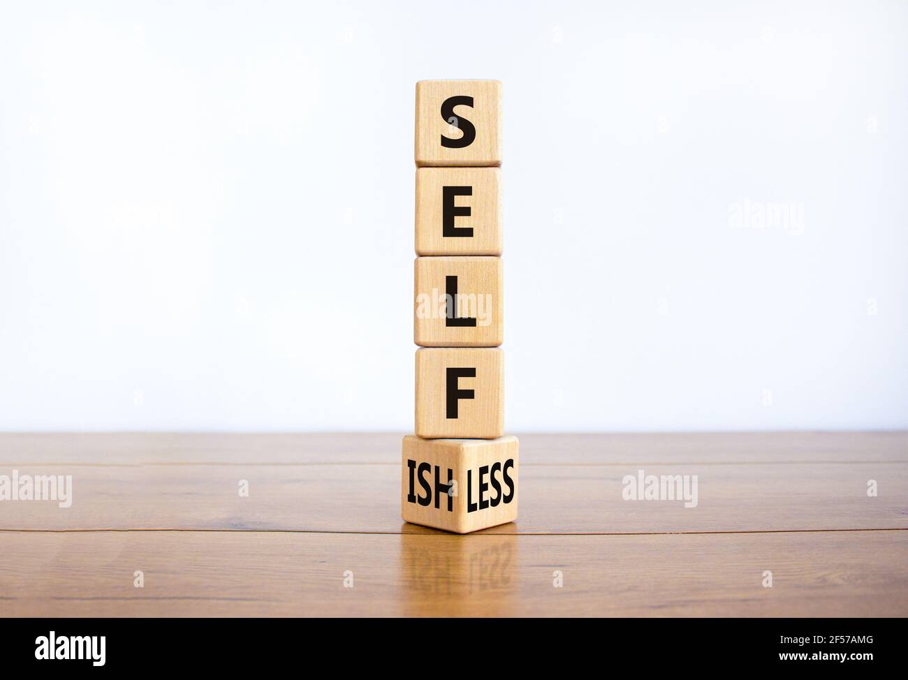 Selbstsüchtiges oder selbstloses Symbol. Drehte Würfel und änderte das Wort 'Selfish' zu 'Selfless'. Schöner weißer Hintergrund, Kopierbereich. Business, psuchologisch Stockfoto