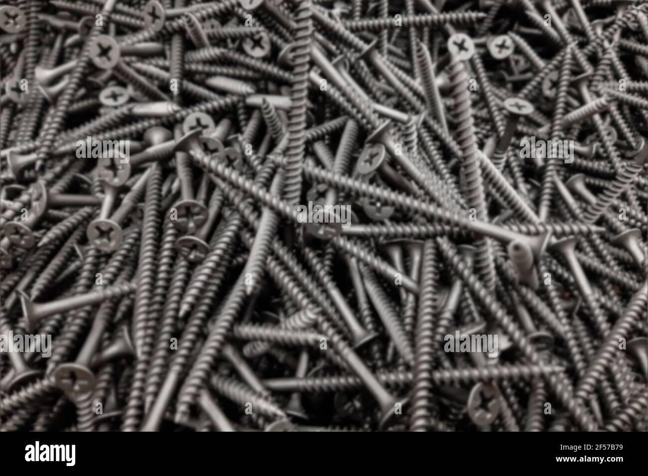 Selbstschneidende Schraube Silber Stahl Lot Stapel Bau Shop Hintergrund Verschwommen. Stockfoto