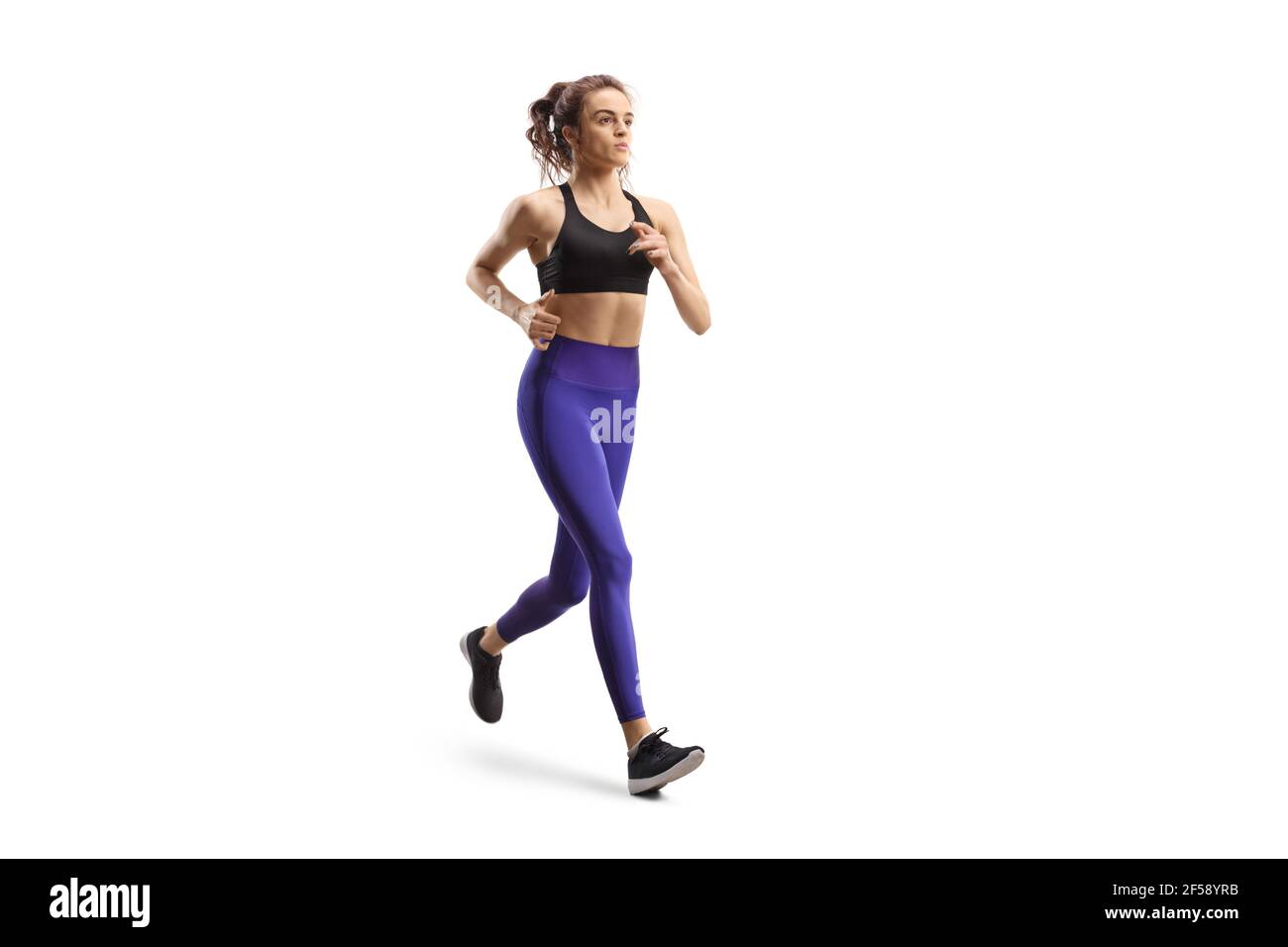 Junge Frau in Leggings und Sport top Jogging isoliert auf Weißer Hintergrund Stockfoto