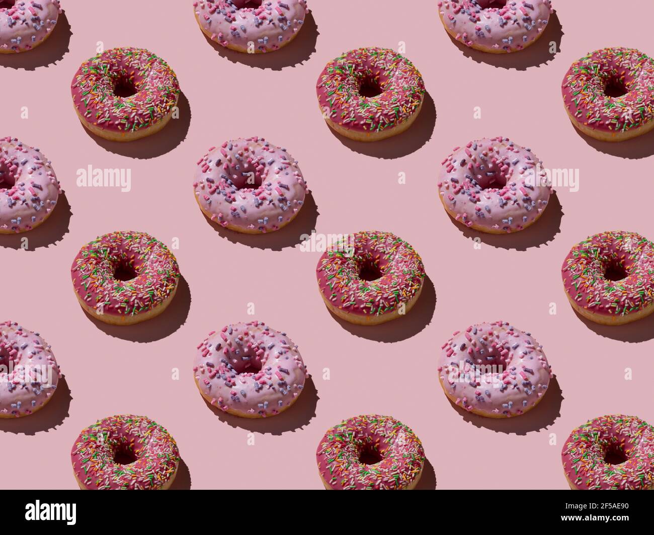 Donuts auf einem rosa Hintergrund Muster Stockfoto