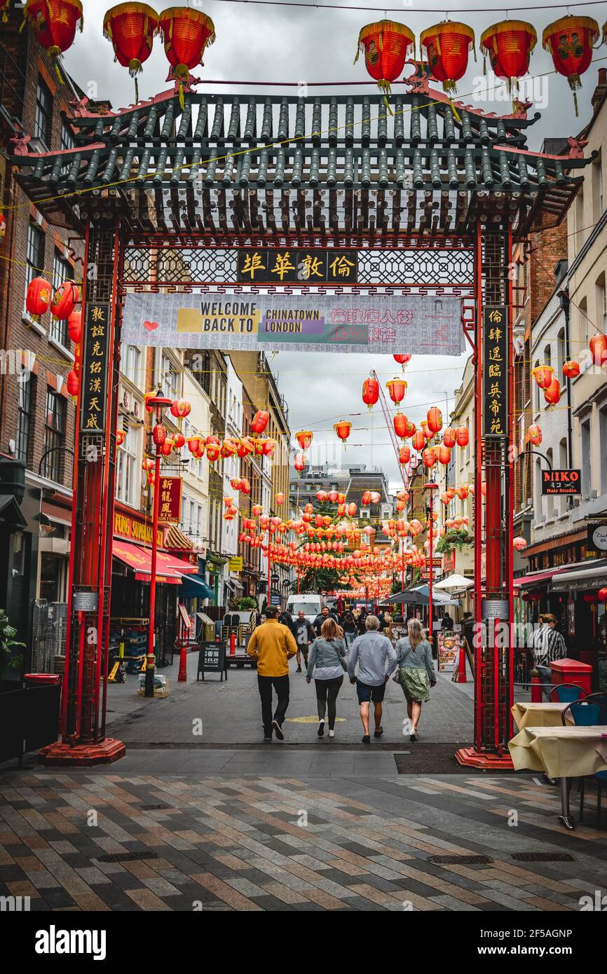 Chinatown Tor in London, England. Leute, die durch das Tor gehen, wahrscheinlich Reisende oder einfach Einheimische, die die Gegend besuchen Stockfoto