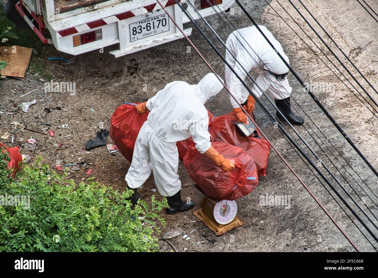 Bangkok, Thailand 03.26.2021 Mitarbeiter der Abfallwirtschaft in persönlicher Schutzausrüstung sammeln die Abfälle von der Cotai Luxury Design Alternative Stockfoto