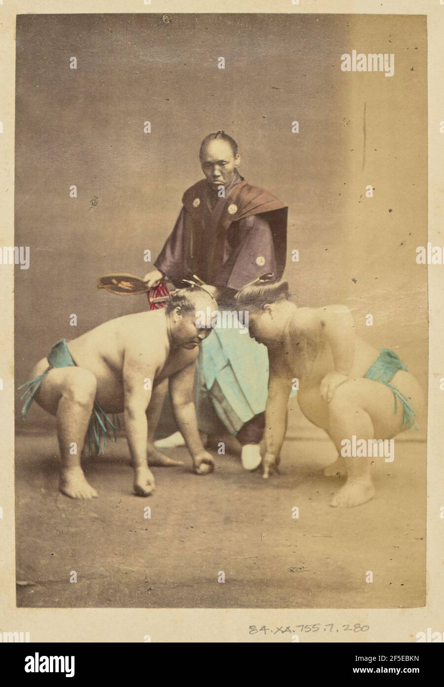 Zwei japanische Sumo-Ringer posierten mit Schiedsrichter. Stockfoto