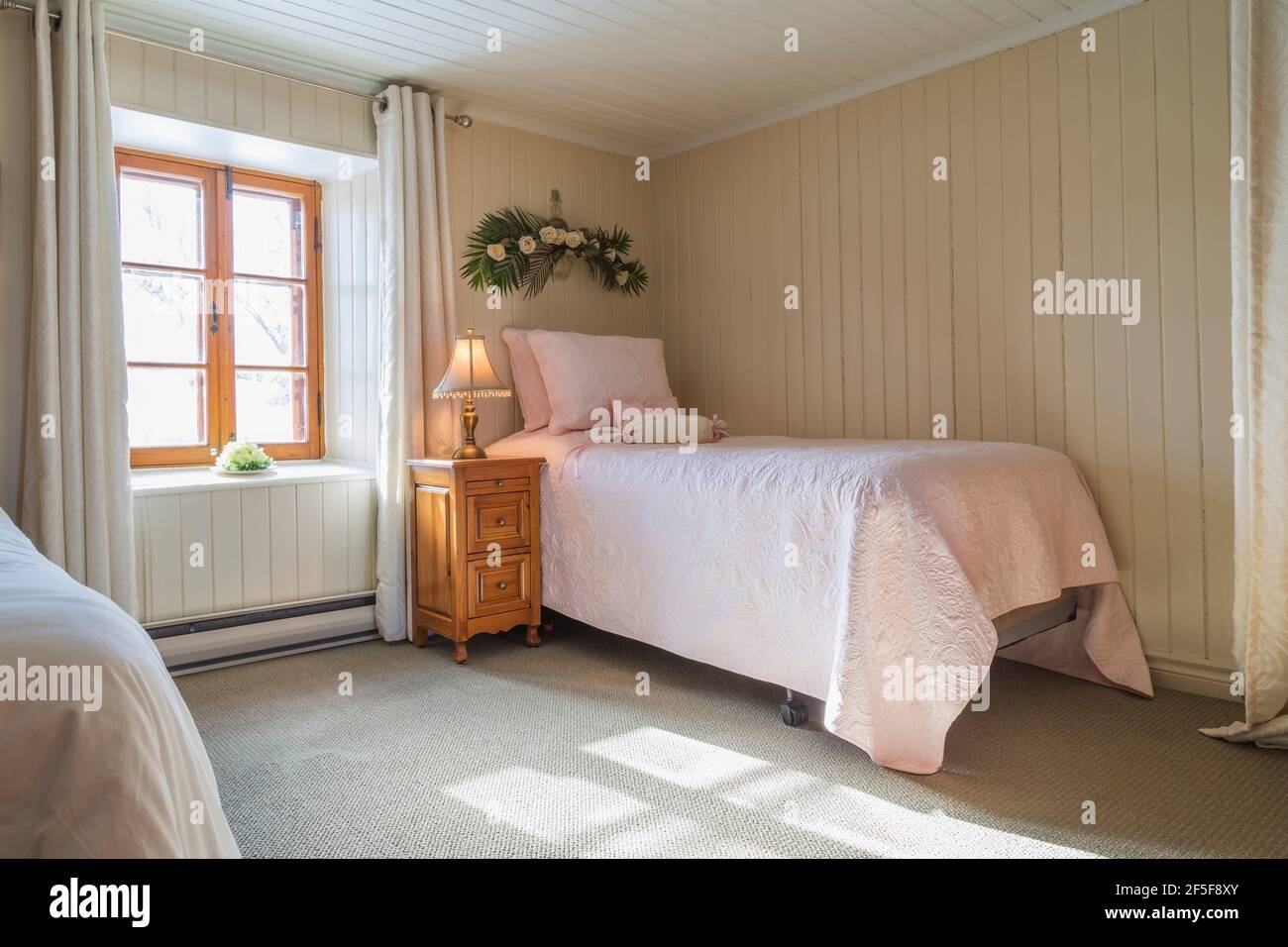 2 Einzelbetten und Nachttisch aus Kiefernholz im Gästezimmer Mit grünem Teppich im Obergeschoss in einem alten 1807 Haus im Cottage-Stil Stockfoto