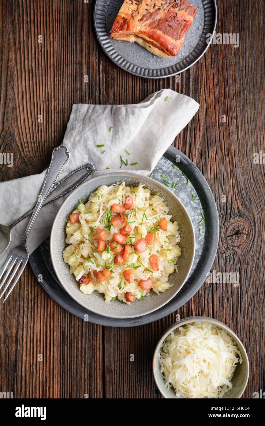 Kapustove halusky bekannt als Strapacky, klassisches Gericht in der Slowakei, gekochte Kartoffelknödel mit Sauerkraut und Zwiebel, gekrönt mit gebratenem Speck und frischem c Stockfoto