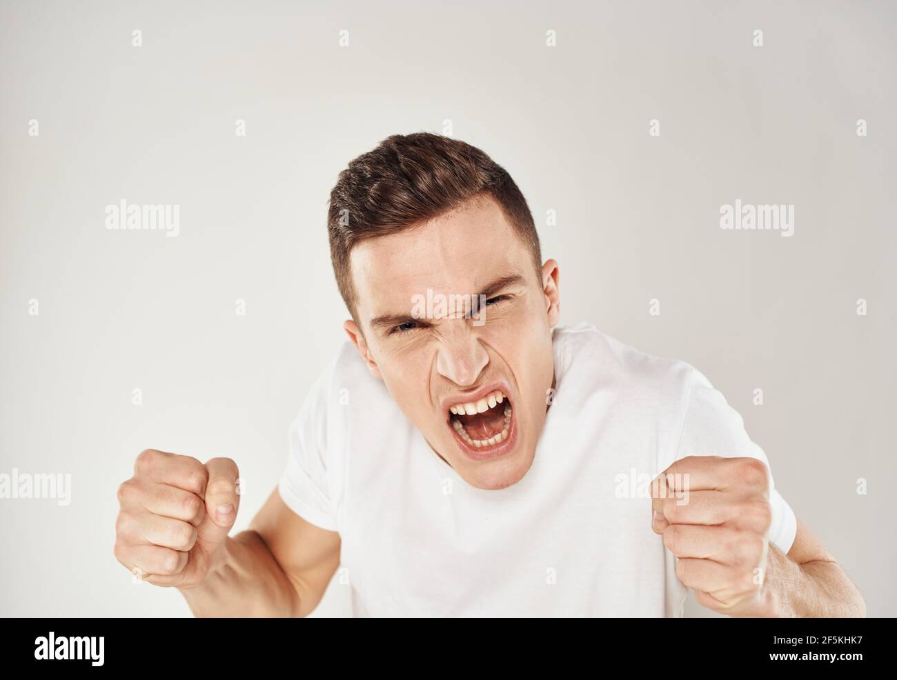 Porträt von Crazy man schreiende Stress Reizbarkeit Modell Licht Hintergrund Stockfoto