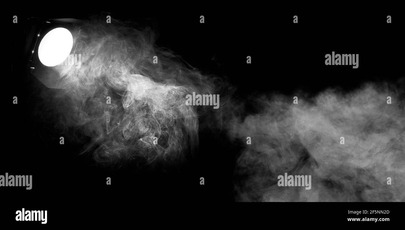 Einzelner aufgehängte Scheinwerfer auf schwarzem Hintergrund. Beleuchtet Rauch und Kanal. Schwarz-Weiß 3D Abbildung Stockfoto