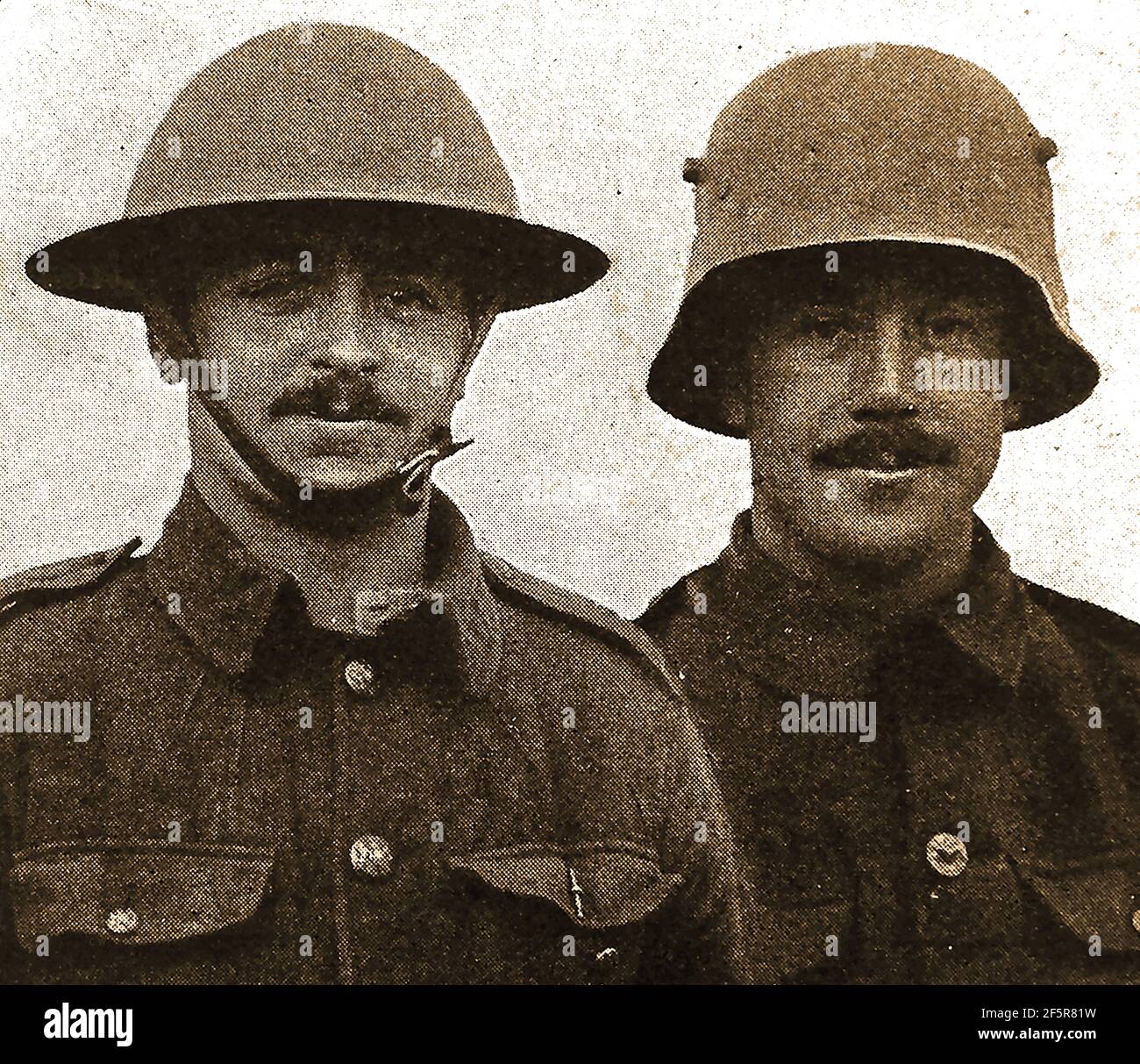 Ein WWI Zeitung Verbindung zwischen den britischen und deutschen Soldaten Helme. Weder wurden als so modisch wie die französische Version. Stockfoto