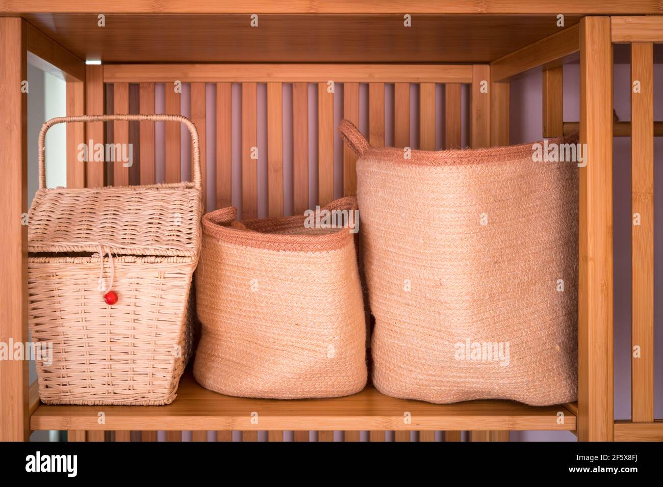 Damen-Boxen, Körbe, Behälter aus Holz natürlichen Materialien, in einem stilvollen Kleiderschrank, modische und elegante Inneneinrichtung gesetzt Stockfoto