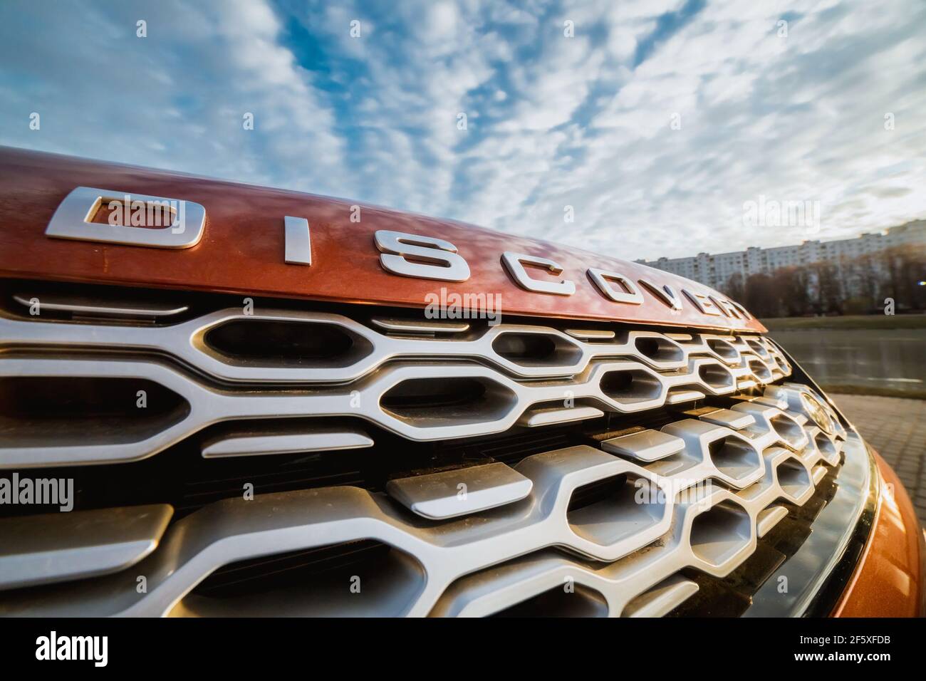 Moskau, Russland - 20. Dezember 2019: Kühlergrill unter der Haube des Premium england suv Land Rover Discovery Sport. Vorderseite des Autos, Nahaufnahme Orange Auto. All-Rad-Auto geparkt. Stockfoto