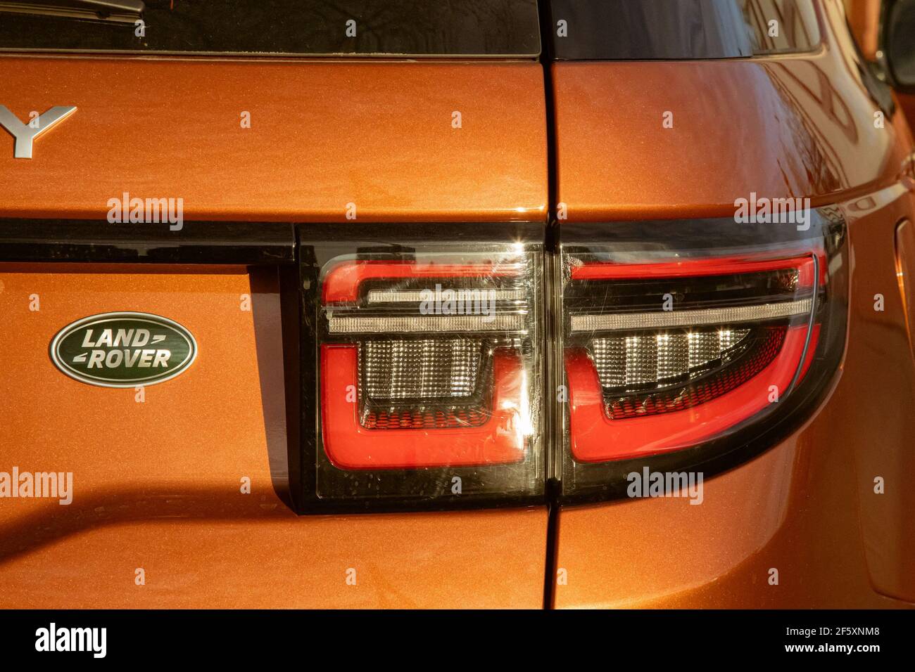 Moskau, Russland - 20. Dezember 2019:Rückansicht und Nahaufnahme der Kofferraumtür und Rückleuchten des neuen Land Rover Discovery Sport 2020. Orange Allradantrieb Auto in der Straße geparkt. Stockfoto