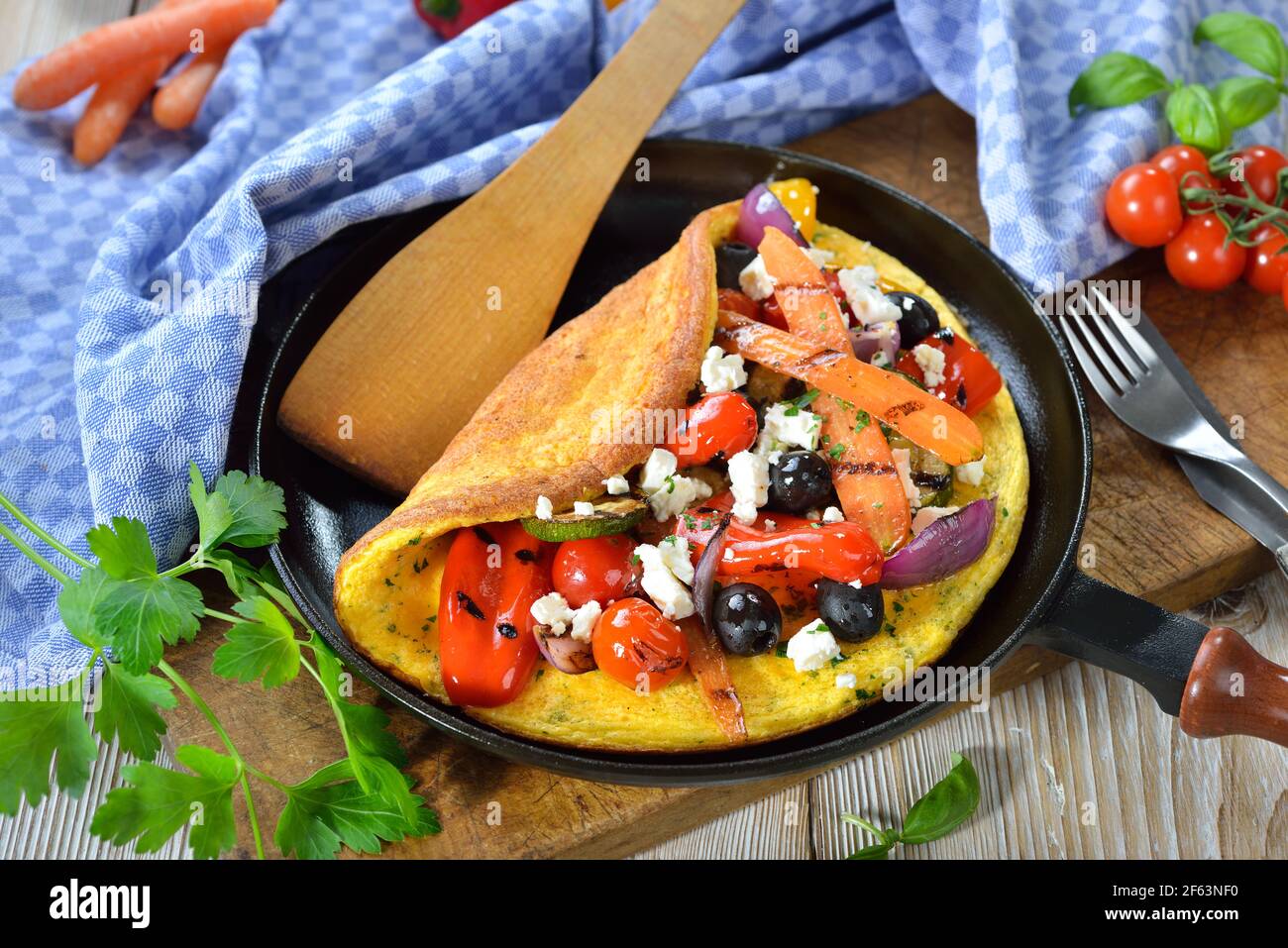 Omelette im griechischen Stil mit gegrilltem Gemüse und Feta-Käse serviert In einer Pfanne Stockfoto