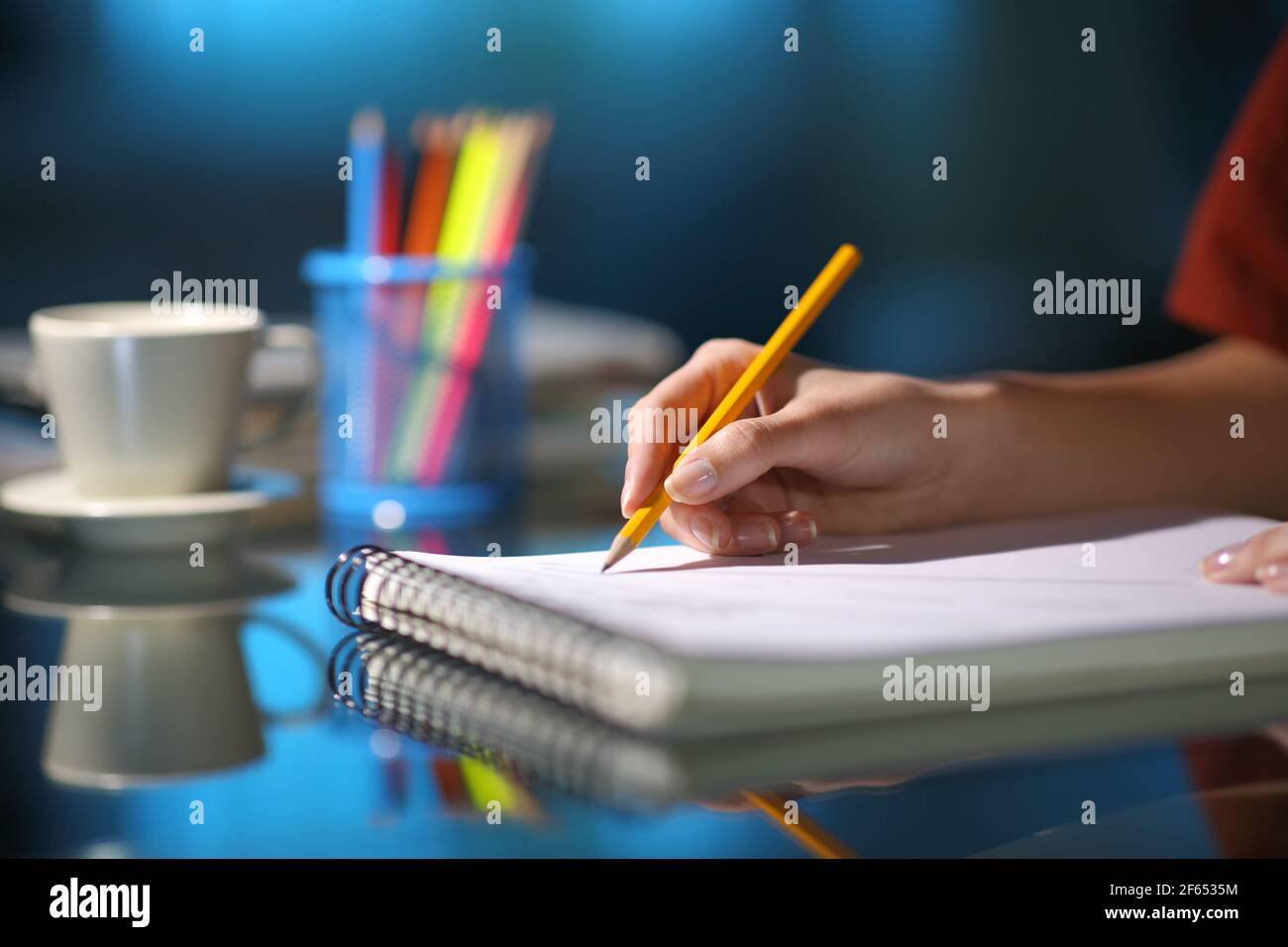 Nahaufnahme eines Künstlers Zeichnung mit einem Bleistift in Ein Notebook in der Nacht zu Hause Stockfoto