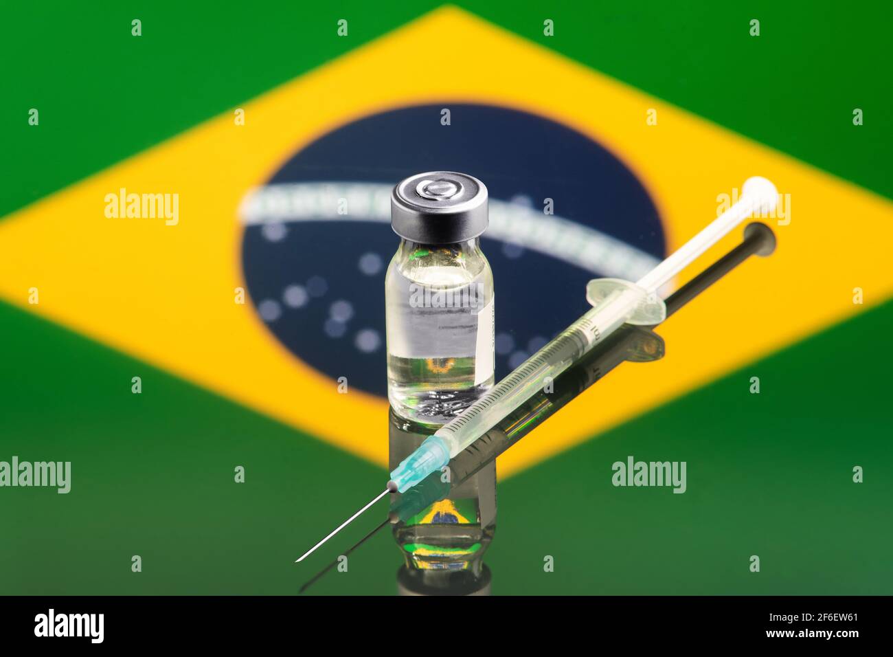 Impfkonzept mit reflektierter und entkoketer Flagge Brasiliens, selektiver Fokus auf Impfstoff Stockfoto
