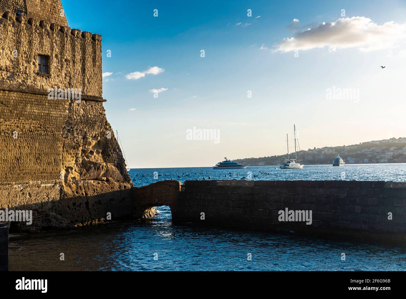 Fassade des Castel dell'Ovo (Egg Castle) und Yachten und Segelboote auf dem Golf von Neapel, Italien Stockfoto