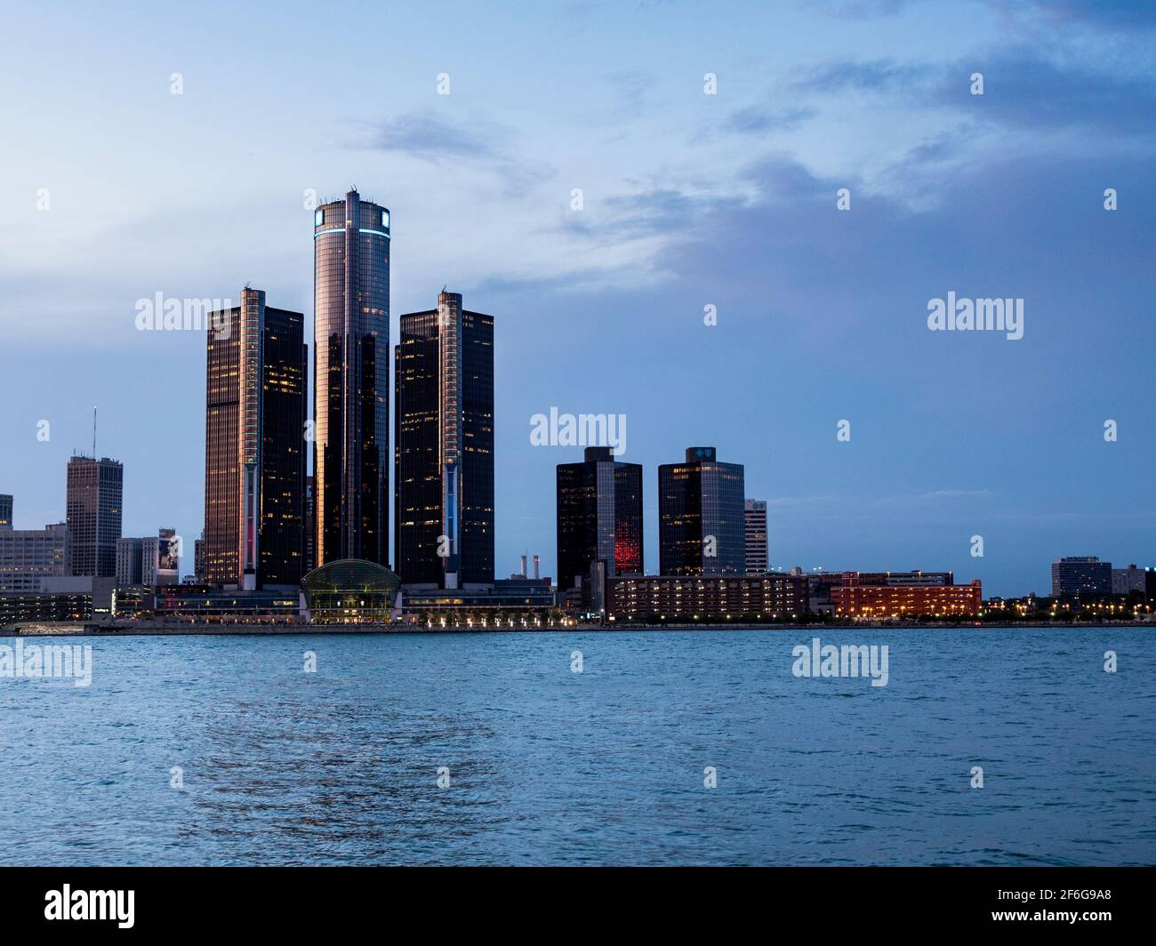 Nach dem Glühen auf dem Renaissance Center in der Innenstadt von Detroit Michigan: Nach dem Sonnenuntergang beginnen die hohen Gebäude des Renaissance Center dominiert von der GM-Turm in Detroit zu leuchten. Detroit River im Vordergrund. Stockfoto