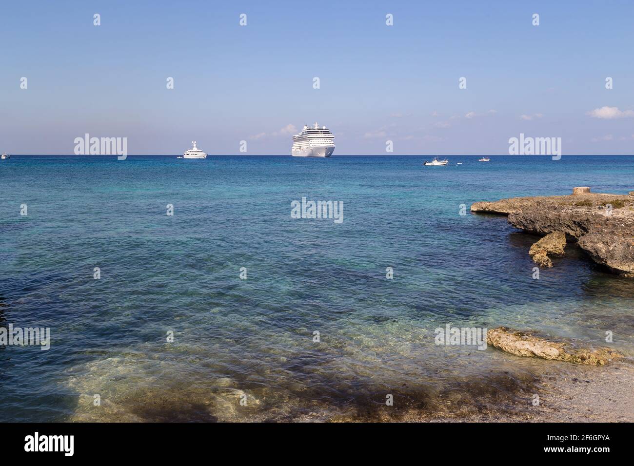 Großes, wunderschönes Luxuskreuzfahrtschiff am karibischen Meer, mit blauem Himmel und weißen Wolken im Hintergrund. Stockfoto