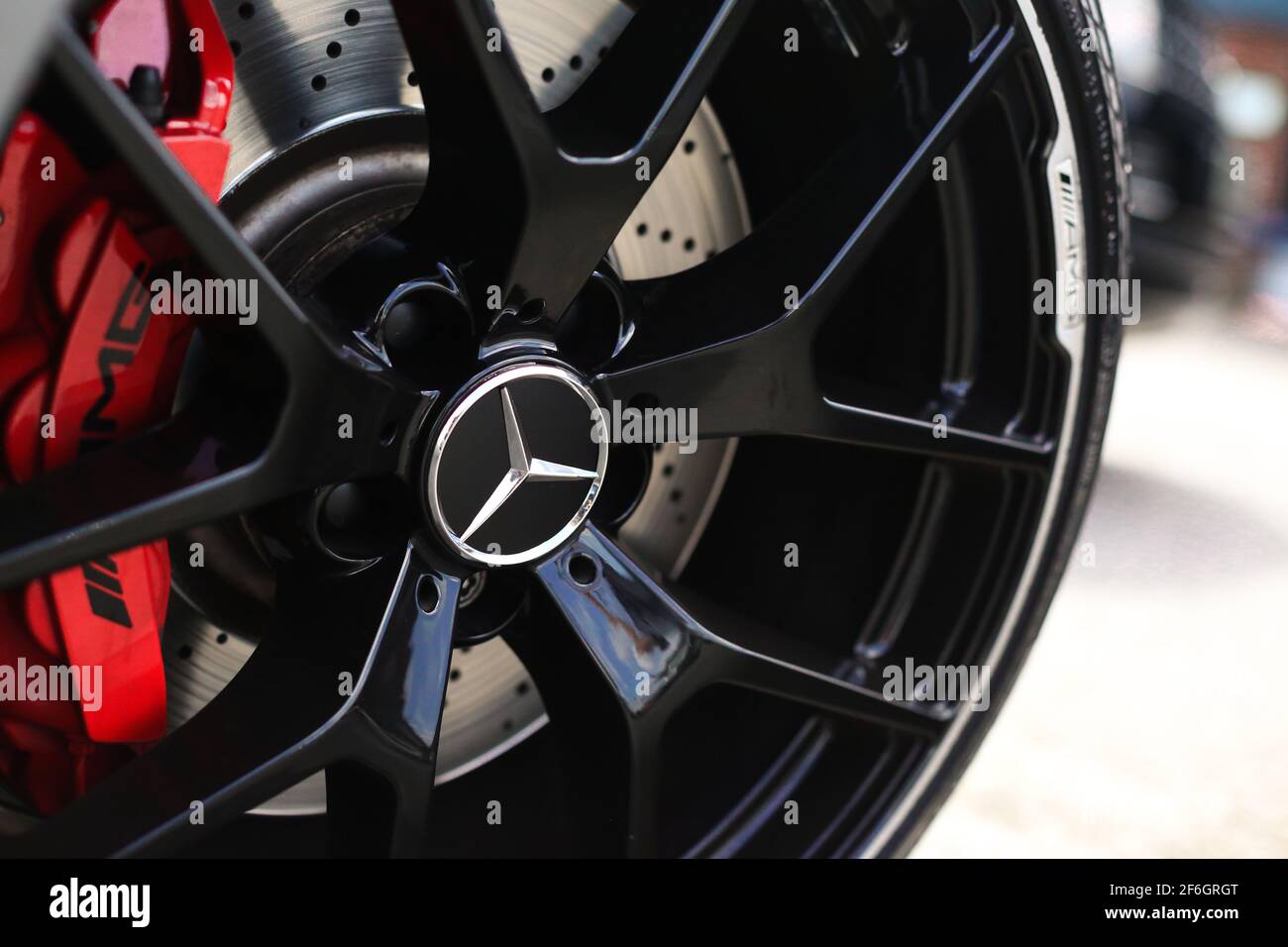 Das schwarze Vorderrad in Glänzend auf EINEM Mercedes-Benz des Jahres 2012 C63 AMG W204 507 Edition mit roten Bremssättel und Keramikscheiben Stockfoto