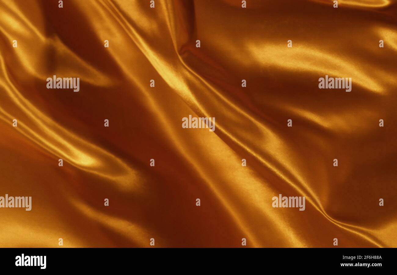 Abstrakter Hintergrund Gold Seide oder Satin Luxus Stoff Textur Stockfoto