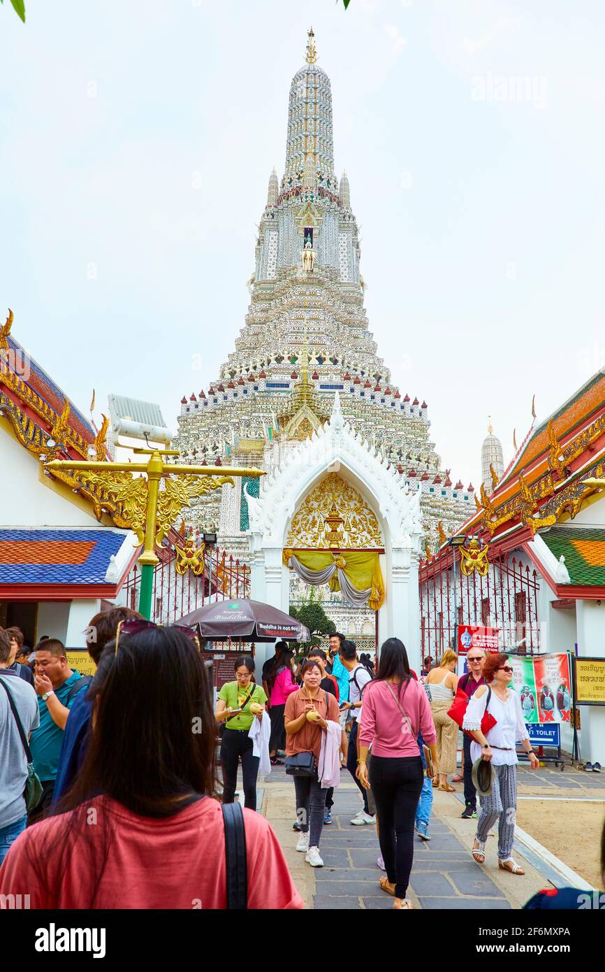 Touristen kommen und gehen, um Wat Arun Ratchawararam Ratchawora Mahavihara, den Tempel der Morgenröte, zu besuchen Stockfoto