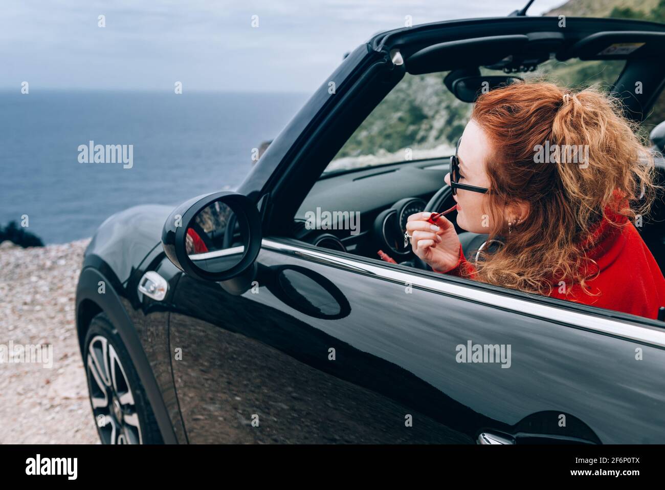 Junge Frau im Cabrio Stockfoto