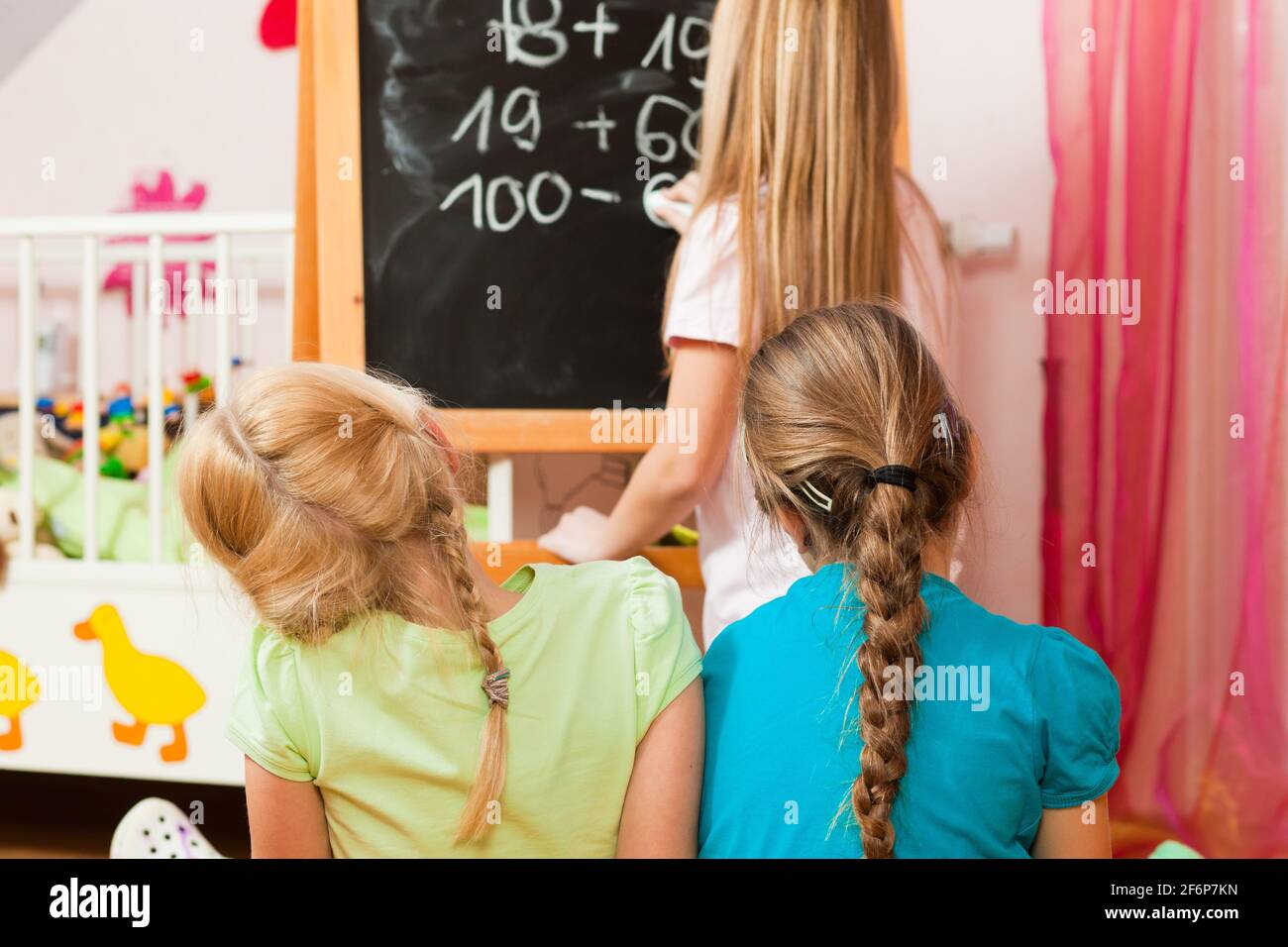 Kinder - Schwestern - Schule in ihrem Zimmer spielen Stockfoto