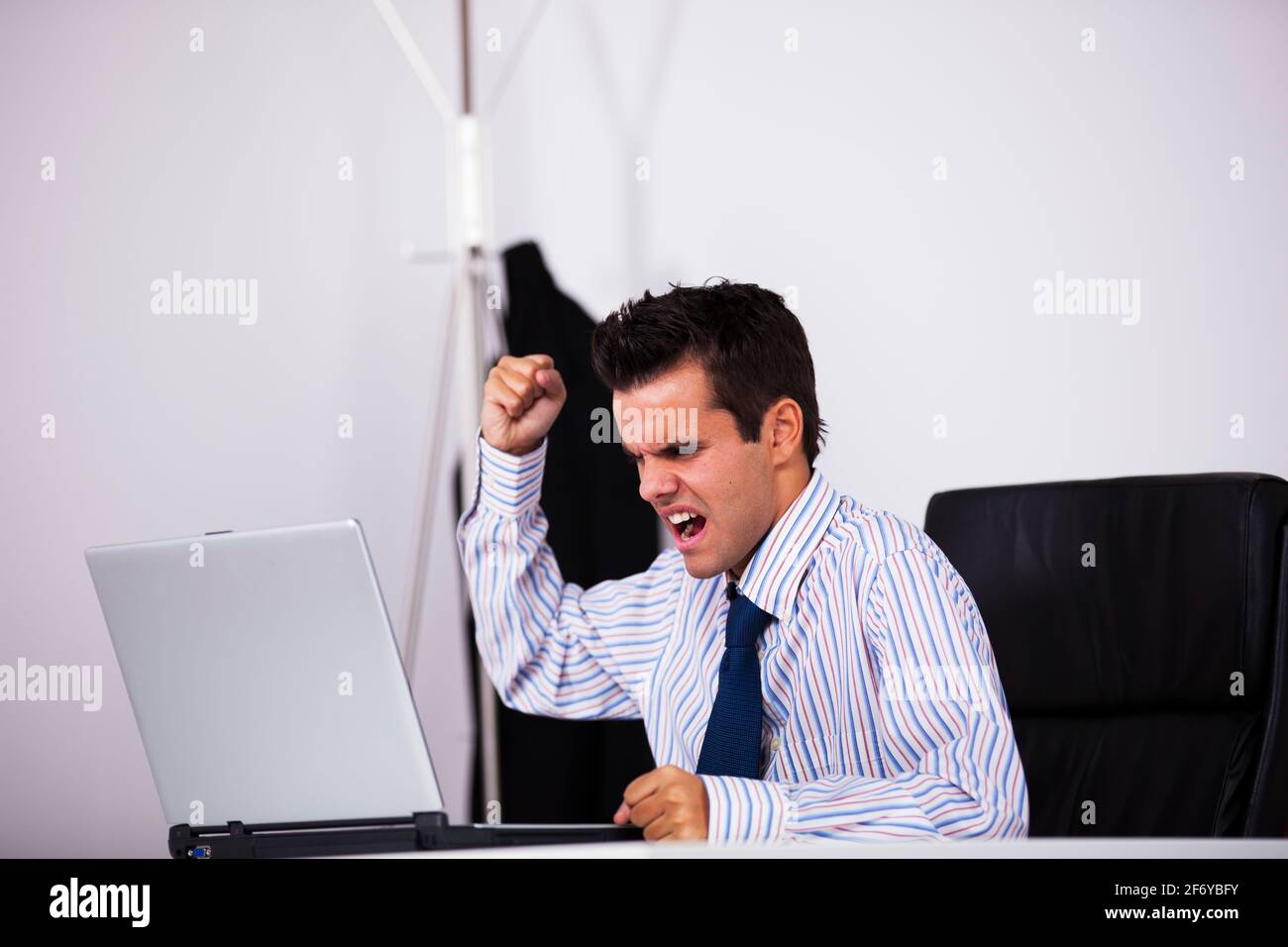 Bereit, seinen Laptop zu zertrümmern wütend Geschäftsmann Stockfoto