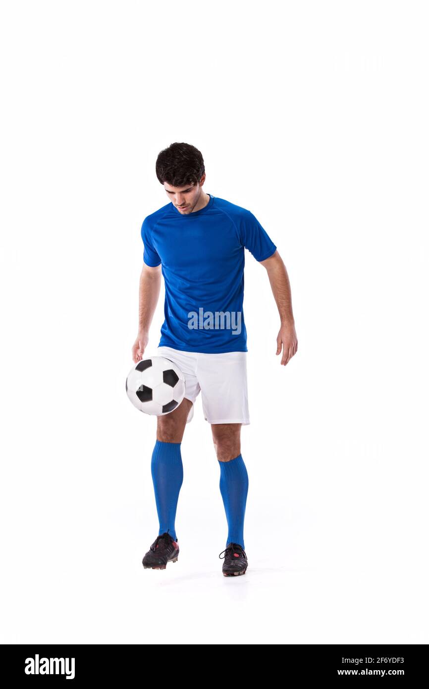 Fußball-Spieler mit einem Fußball Stockfoto