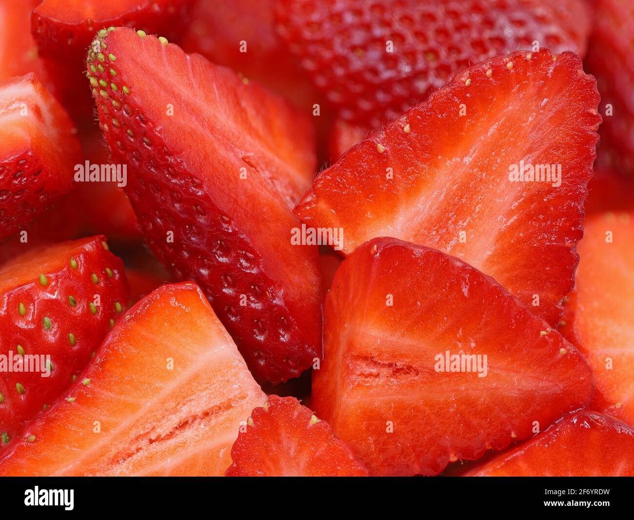 Nahaufnahme von in Scheiben geschnittenen reifen roten Erdbeeren, Superfood Hintergrund Stockfoto