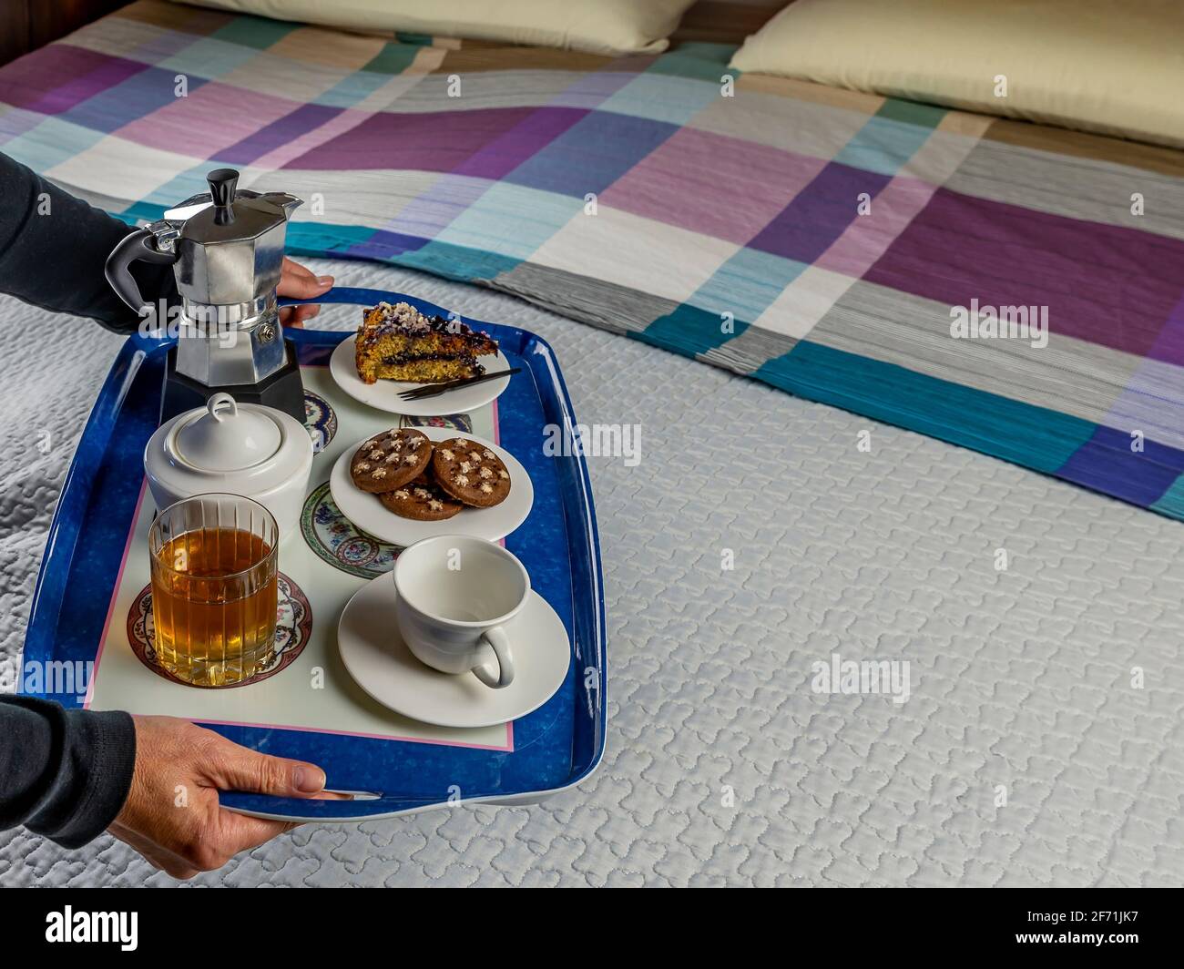 Ein köstliches Frühstück wird im Bett auf einem blauen serviert Fach Stockfoto