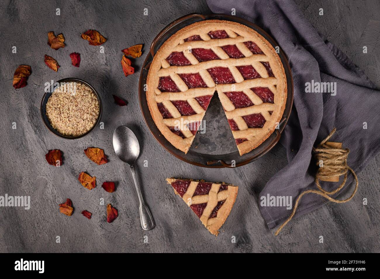 Draufsicht auf hausgemachten Kuchen namens 'Linzer Torte', ein traditionelles österreichisches Shortcake-Gebäck mit Obstkonserven und gemahlenen Nüssen mit Gitterdessig Stockfoto