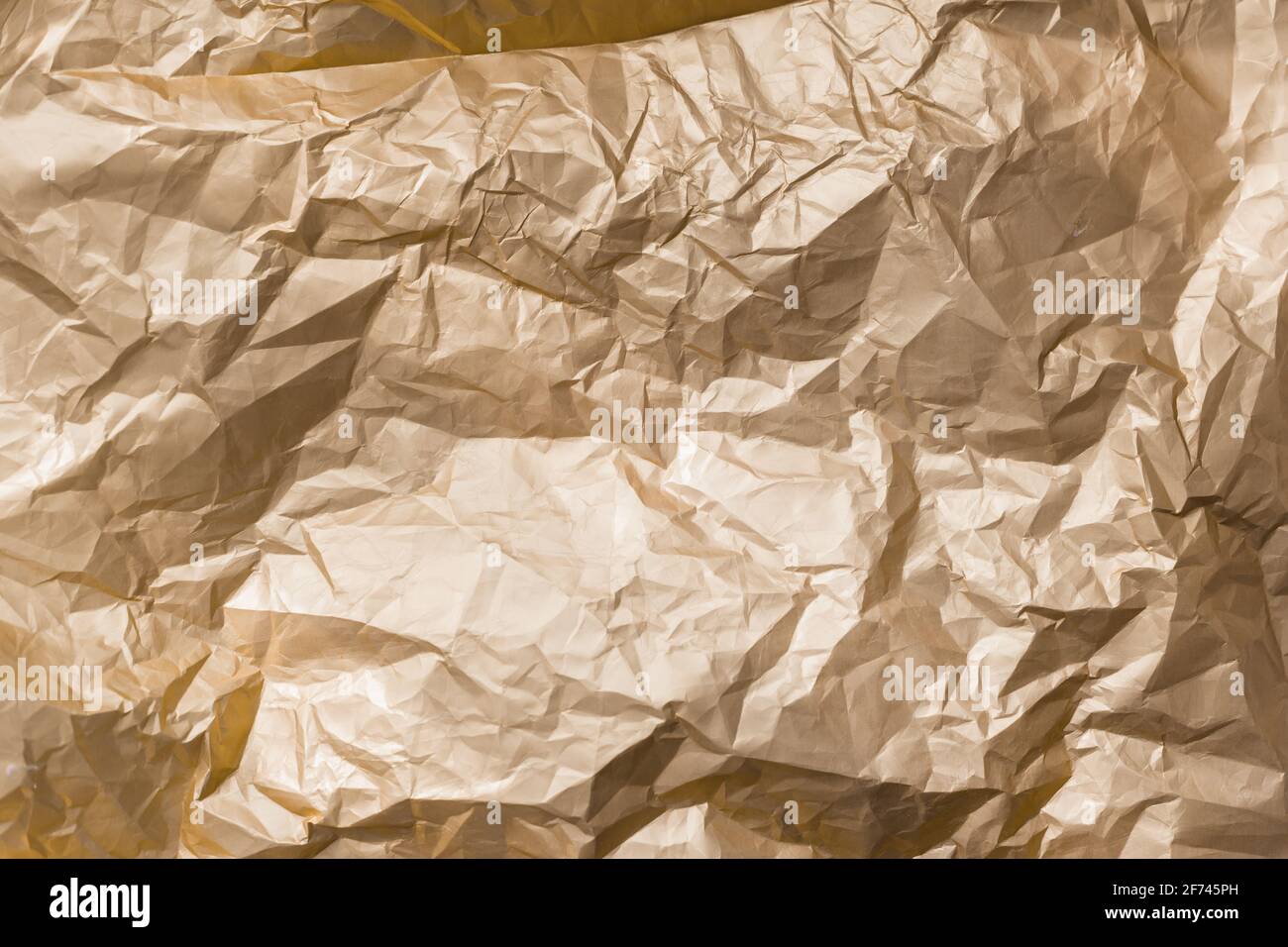 Abstrakt Hintergrund Textur golden glänzend knitterten Folie Metallblech Stockfoto