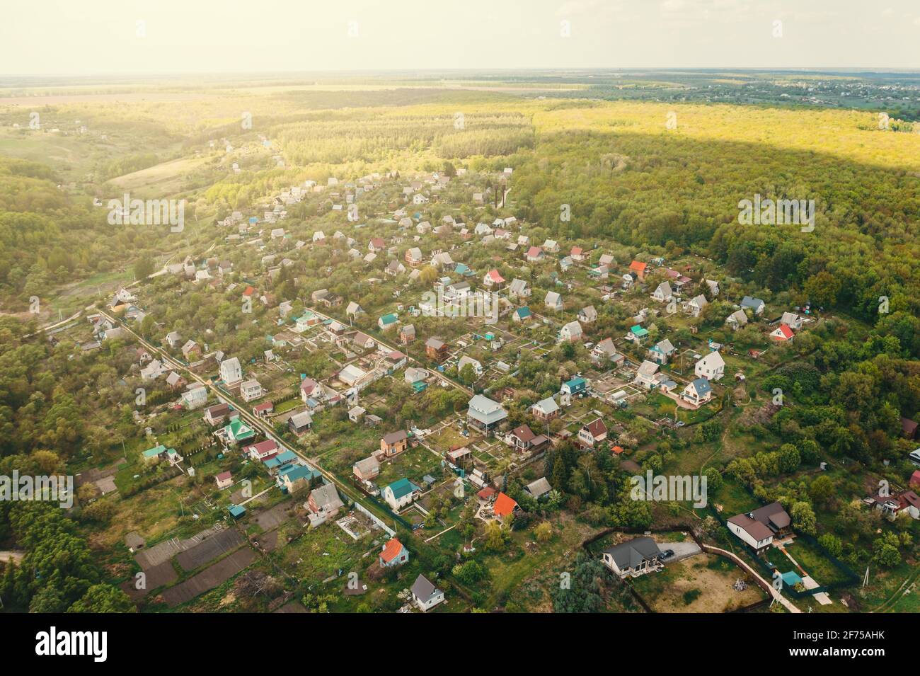 Kleines Dorf mit Häusern in grüner Natur Wald mit frischer Luft, Luftaufnahme von Drohne. Stockfoto