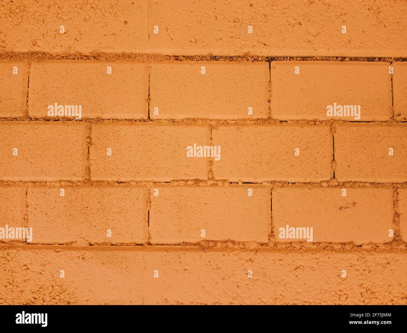 Nahaufnahme eines horizontalen orangefarbenen Backsteinwandtextur-Hintergrunds. Speicherplatz kopieren. Stockfoto