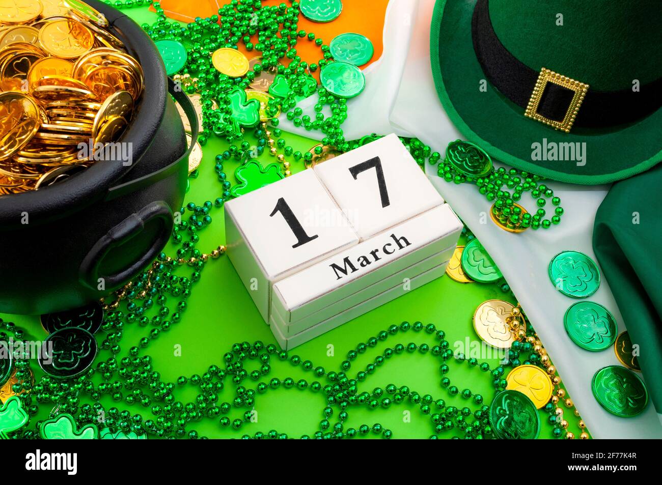 Das Glück des irischen Meme und Happy St. Patricks Day-Konzeptenthema mit einem Kalender, einem Leprechaun-Hut, einer Perlenkette und einem Topf mit Goldmünzen auf dem Irischen Stockfoto