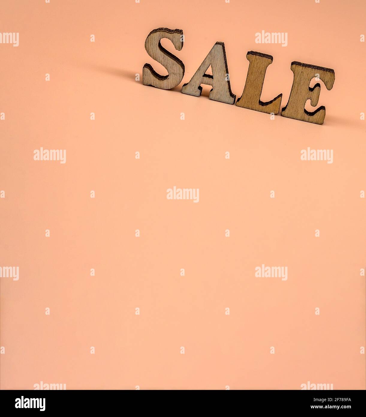 Rabattangebot. Große Briefe Verkauf, Aktion. Holzbuchstaben Rabatt auf orangenen Hintergrund. Stockfoto