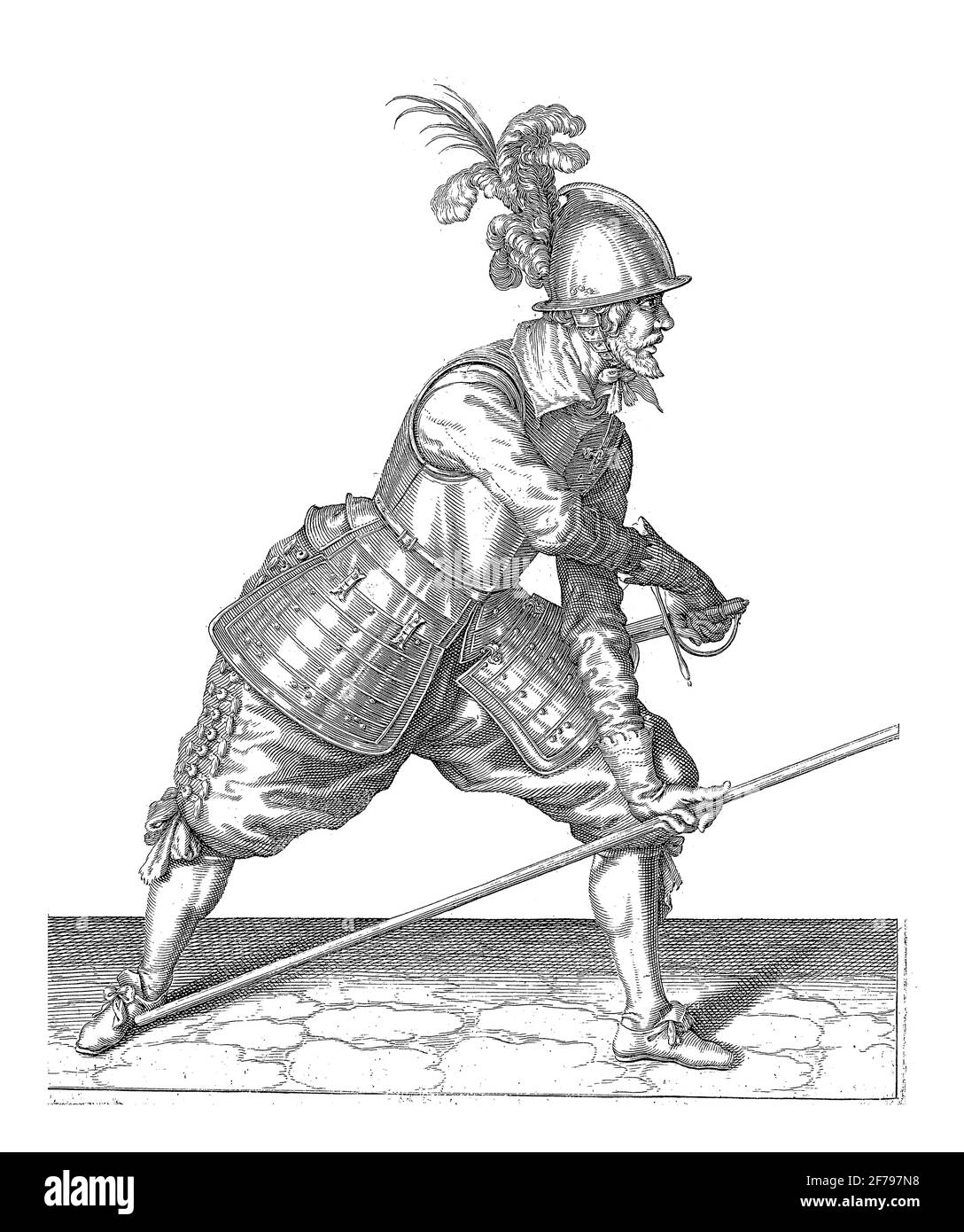 Ein Soldat, voller Länge, rechts, der seinen Speer (Lanze) mit der linken Hand gegen seinen rechten Fuß legt und mit der rechten Hand sein Schwert zieht, Stockfoto